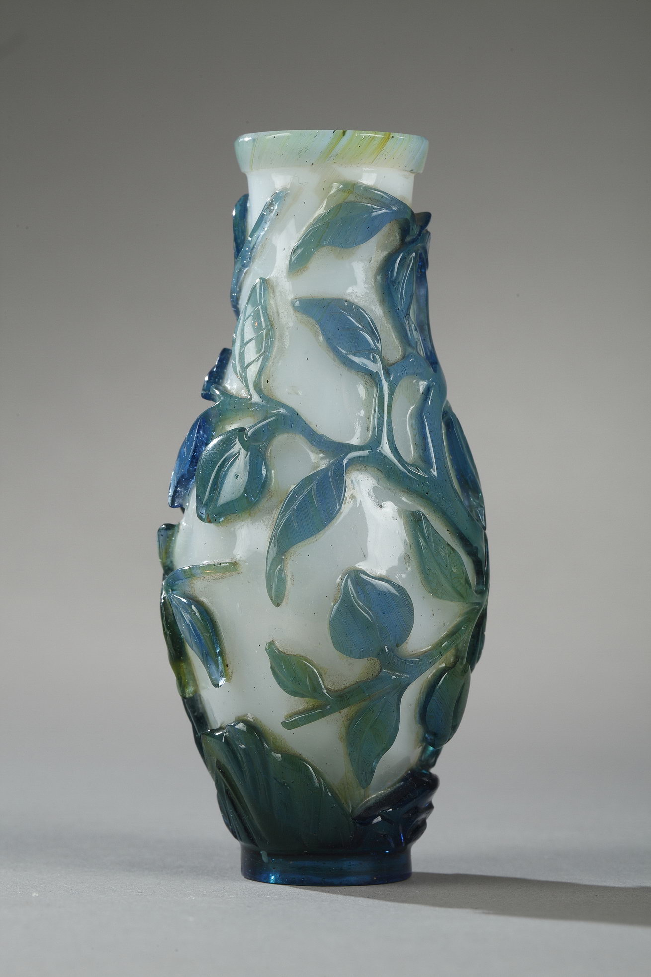 Small vase overlay glass turquoise blue, green on ground white opaque decorated with longevity peach and foliage